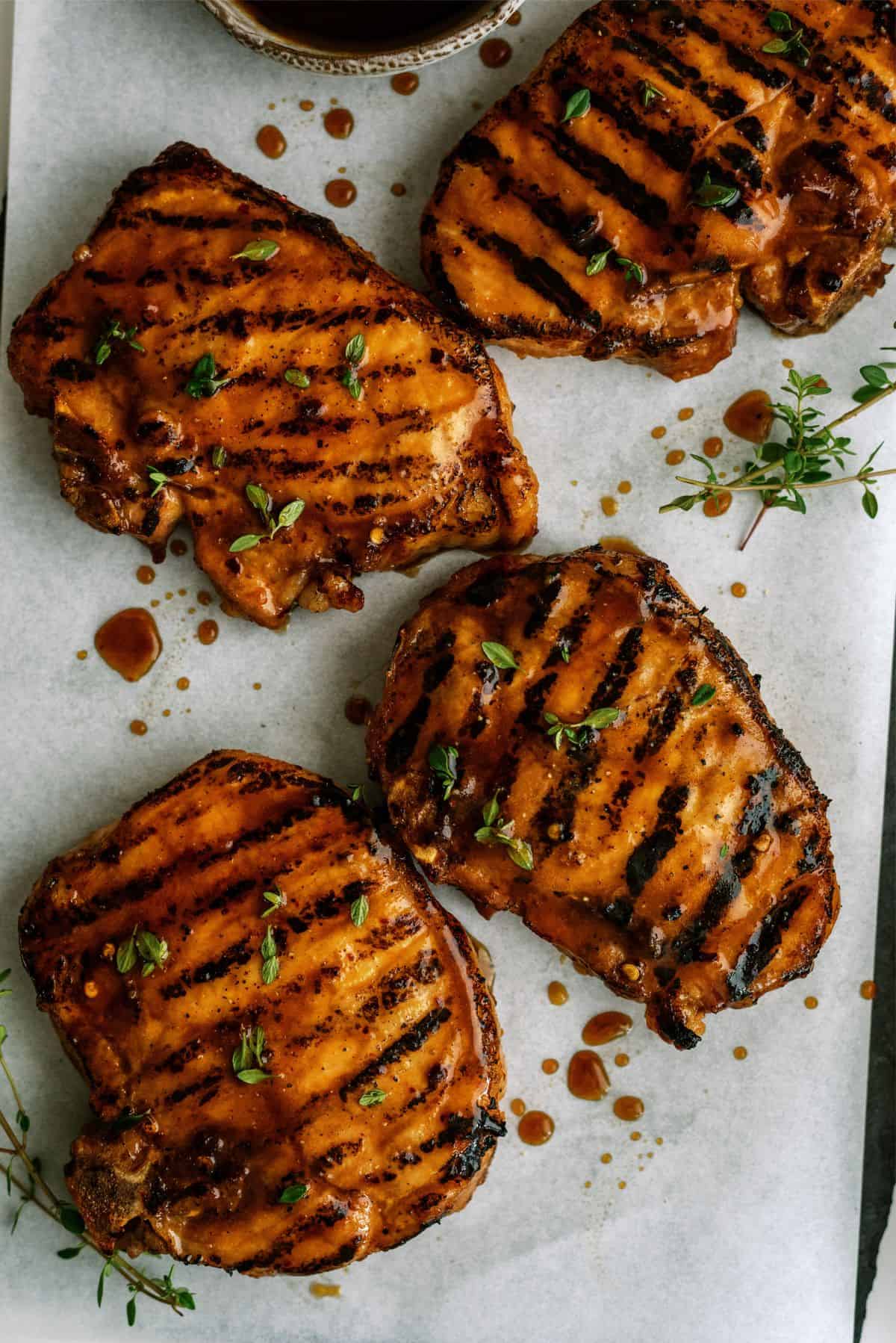 Perfectly Juicy Grilled Pork Chops on a baking sheet