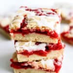 3 Cherry Pie Bars stacked on top of a white plate.