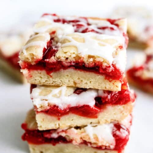 3 Cherry Pie Bars stacked on top of a white plate.