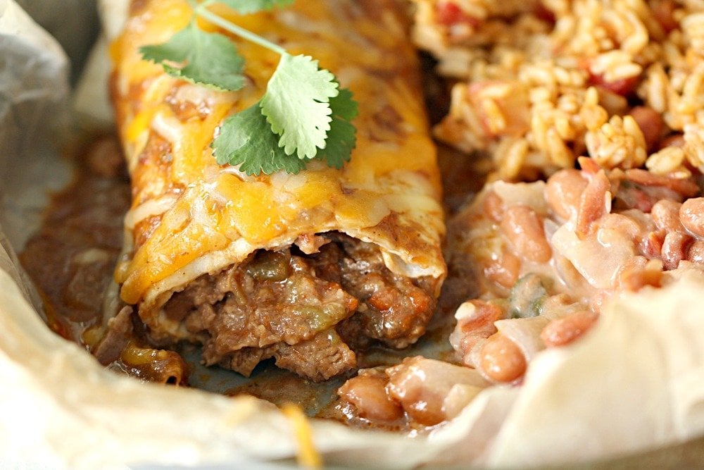 Instant Pot Chile Colorado Beef Burrito on a plate with rice and beans