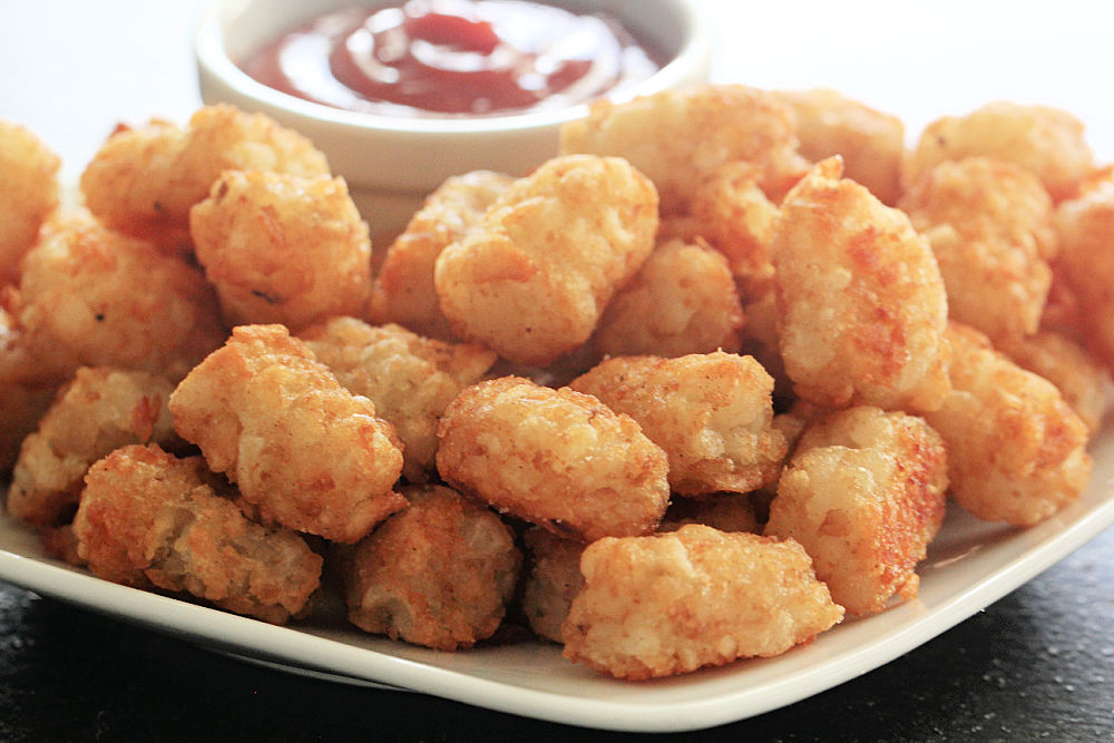 Crispy Tater Tots on a plate with a side of ketchup