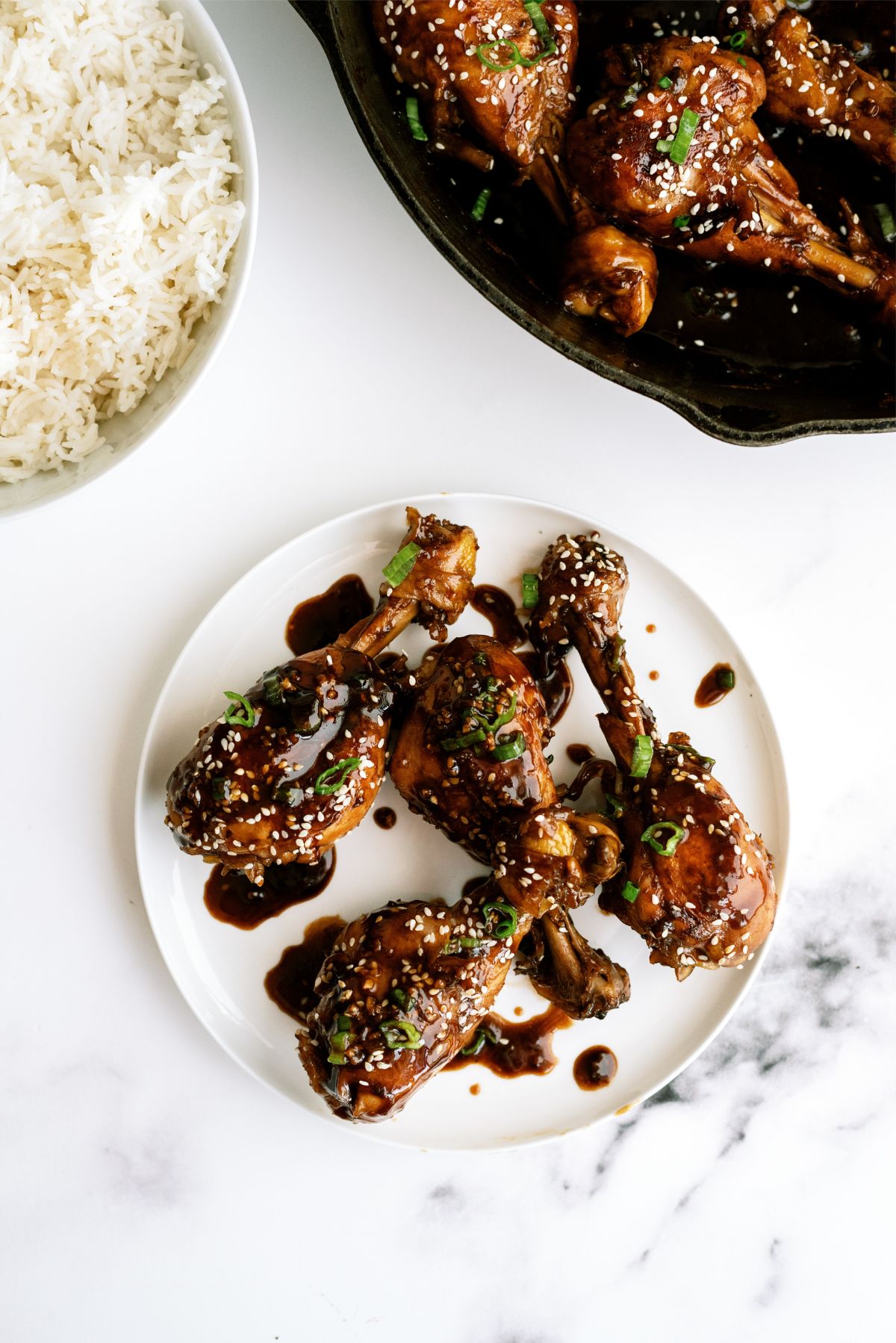 Plate of Asian Glazed Chicken Drumsticks on a table