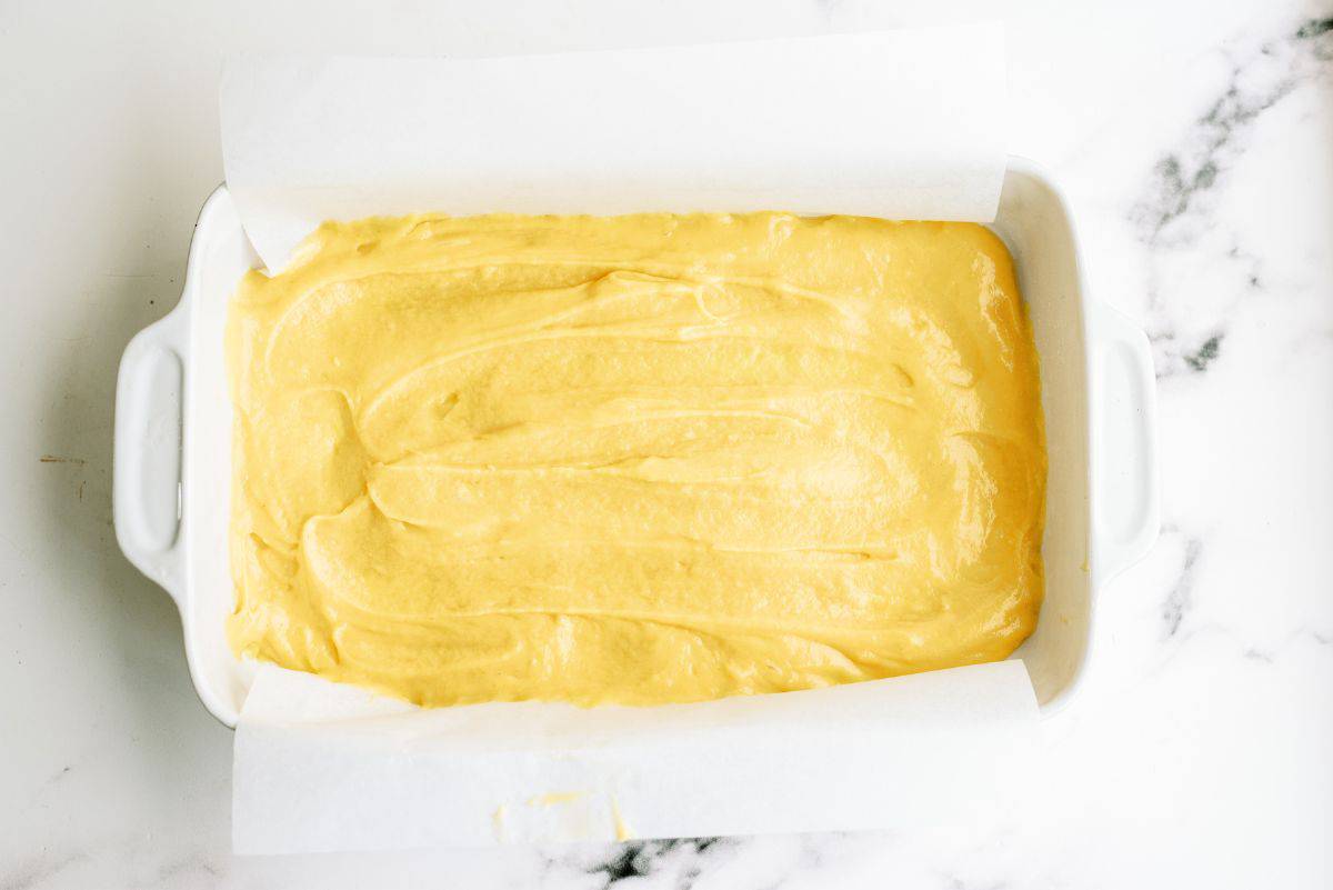 A cake dish with Cream Puff Cake batter on the bottom.