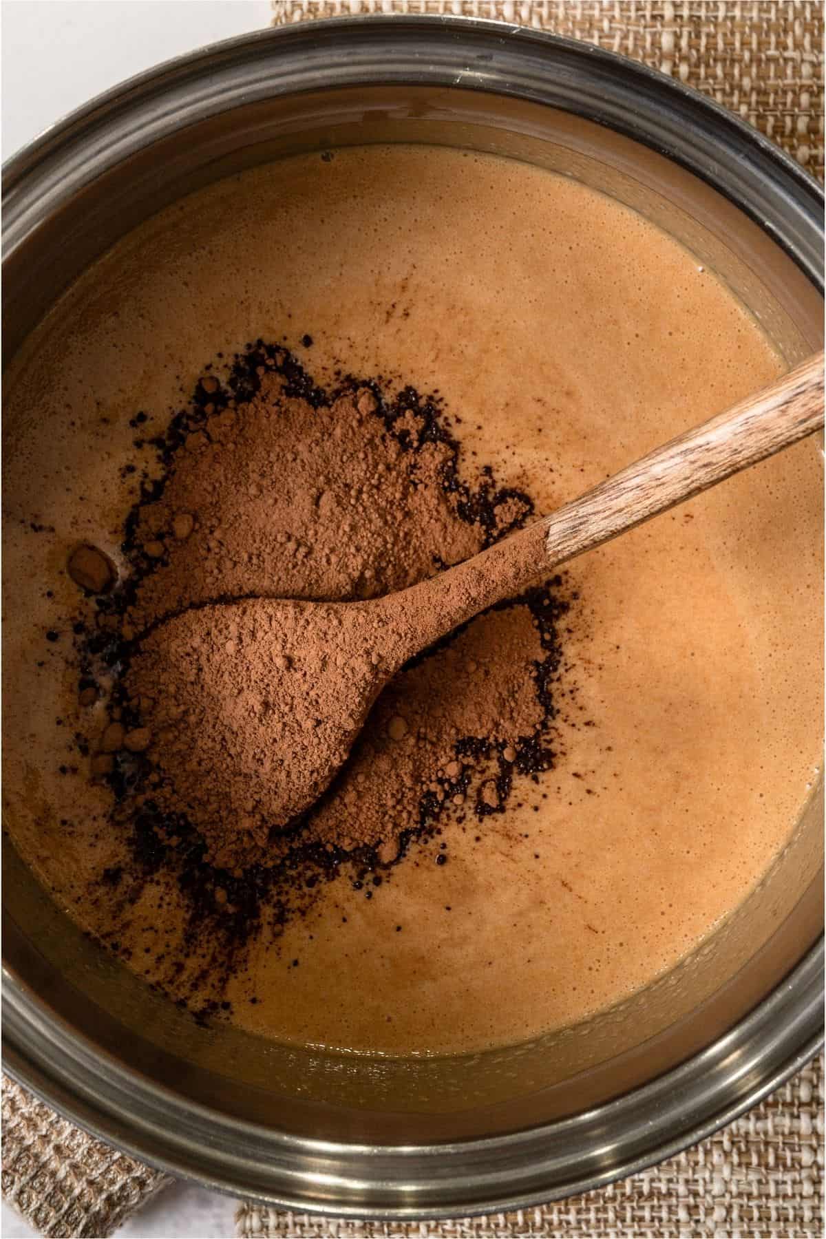 Peanut butter and honey melted in saucepan with cocoa powder added on top.