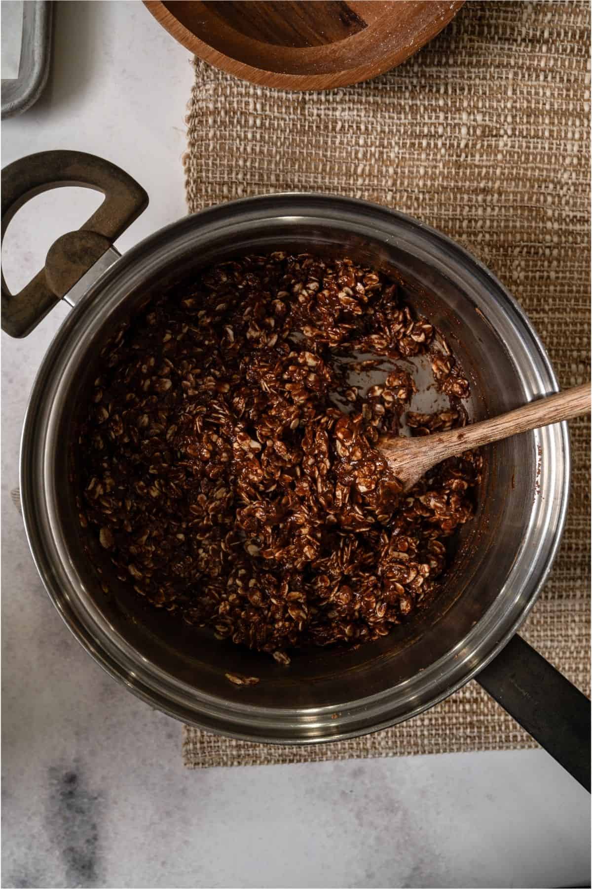 A wooden spoon mixing all the ingredients together.