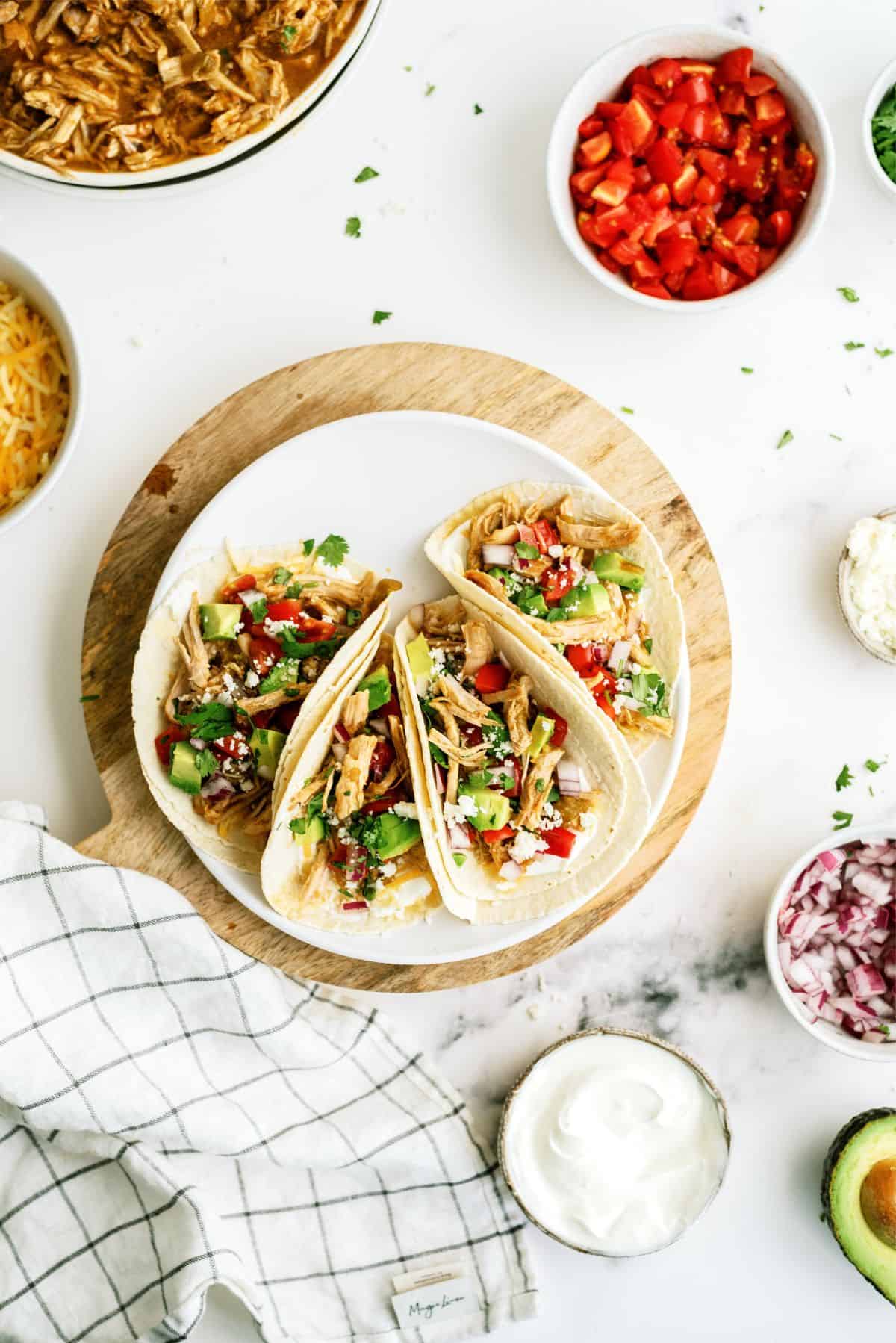 Top view of 3 Instant Pot Green Chile Pork Tacos on a plate