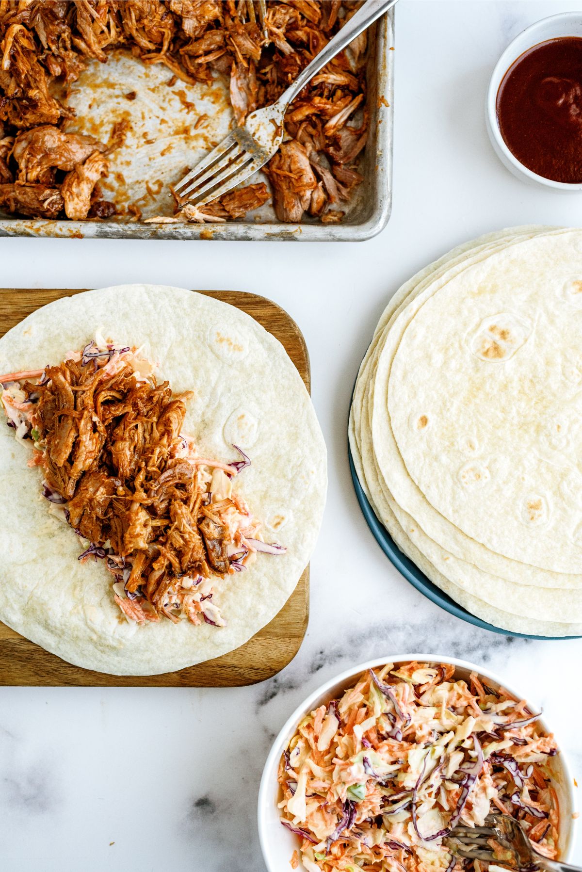 tortilla with pork on it and all the other ingredients to make Instant Pot Honey BBQ Pork Wraps