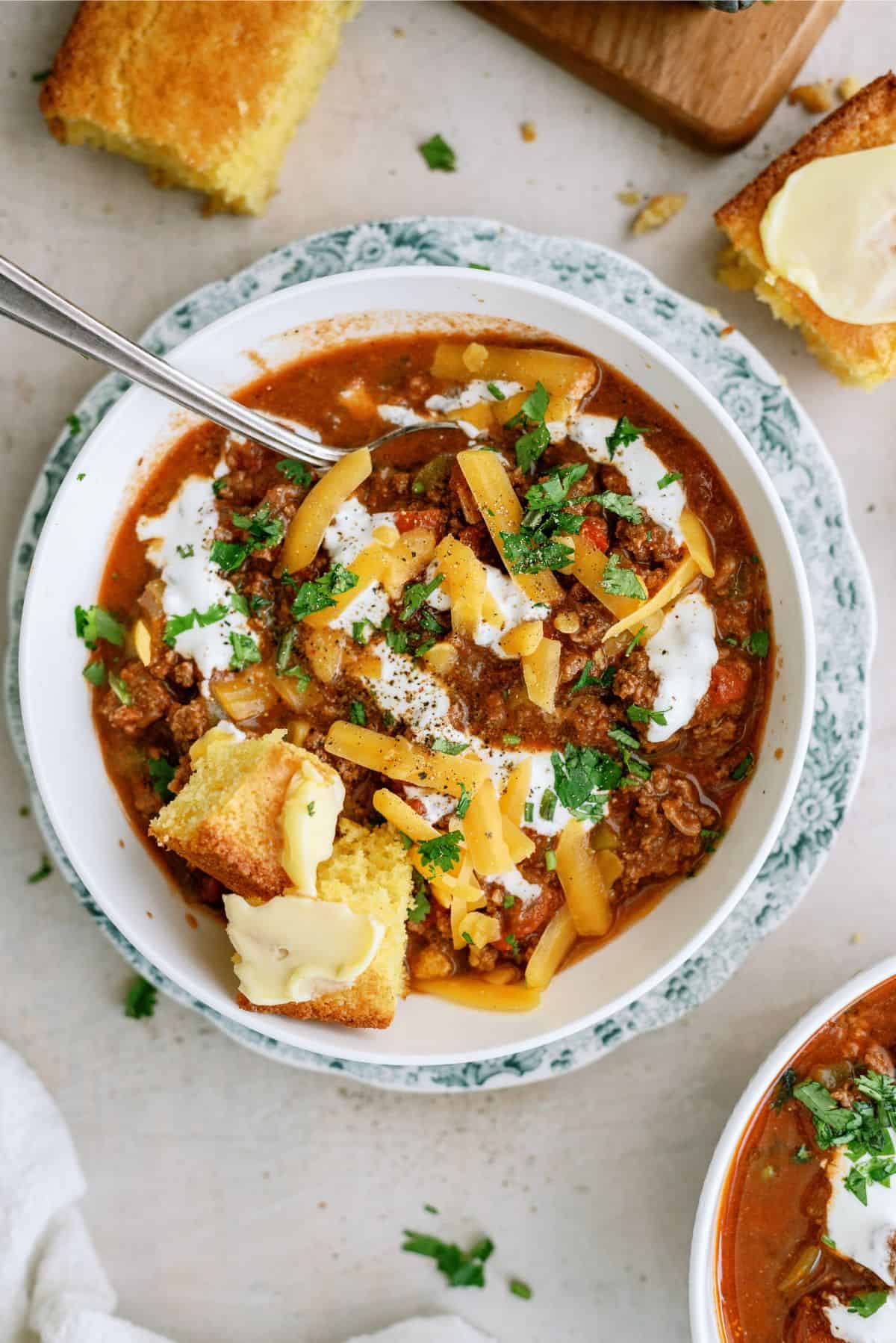 A bowl of Instant Pot No-Bean Chili with Ground Beef with toppings and a spoon