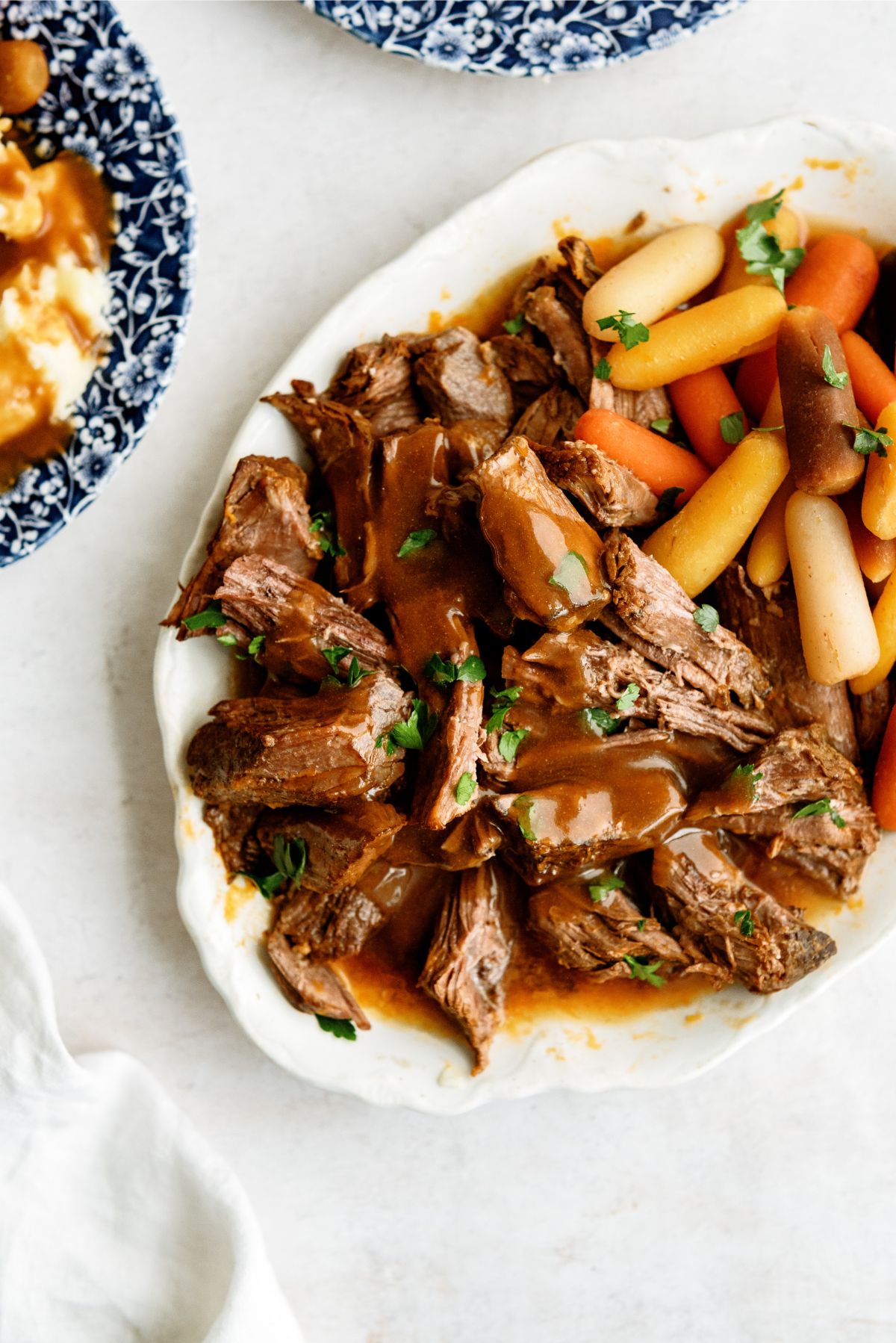 Instant Pot Texas Roadhouse Pot Roast on a serving plate with carrots