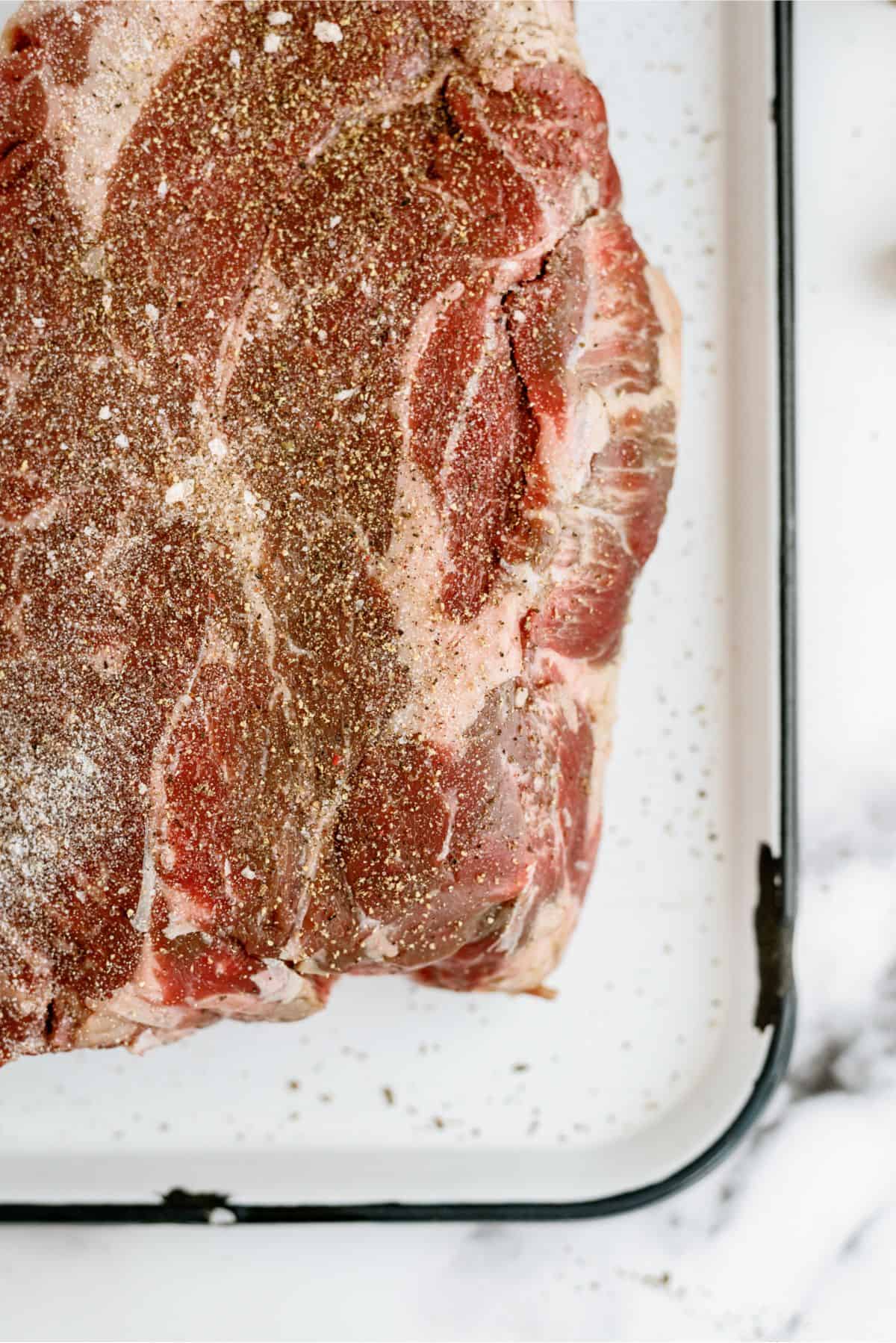 Raw chuck roast seasoned