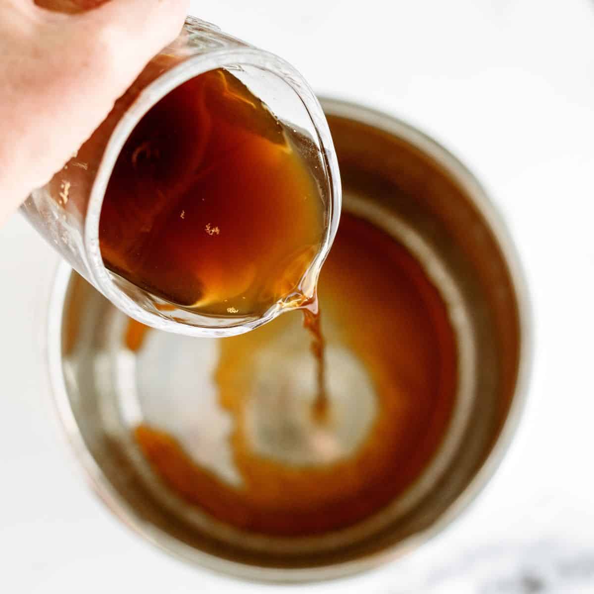 Pouring beef broth into Instant Pot