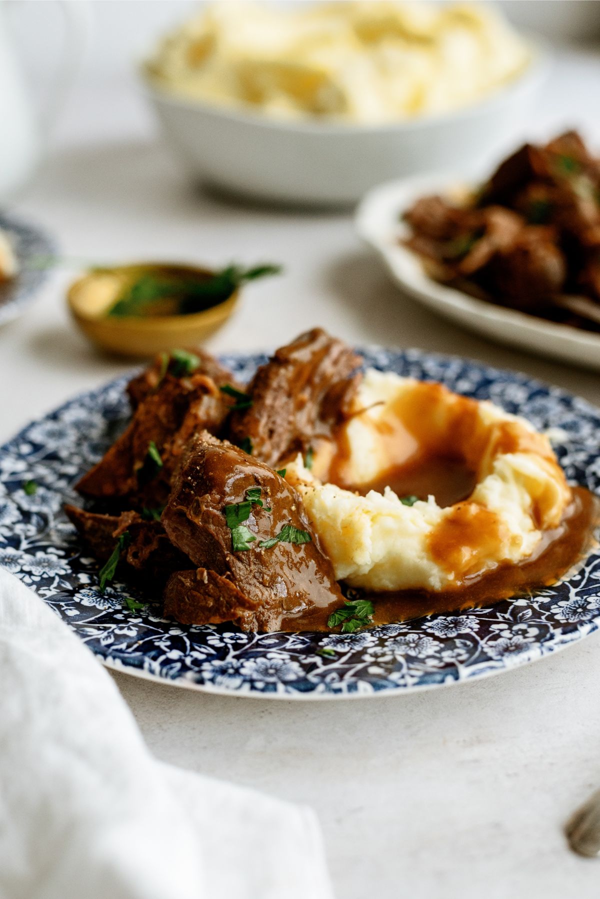 Instant Pot Texas Roadhouse Pot Roast with mashed potatoes and gravy on a plate