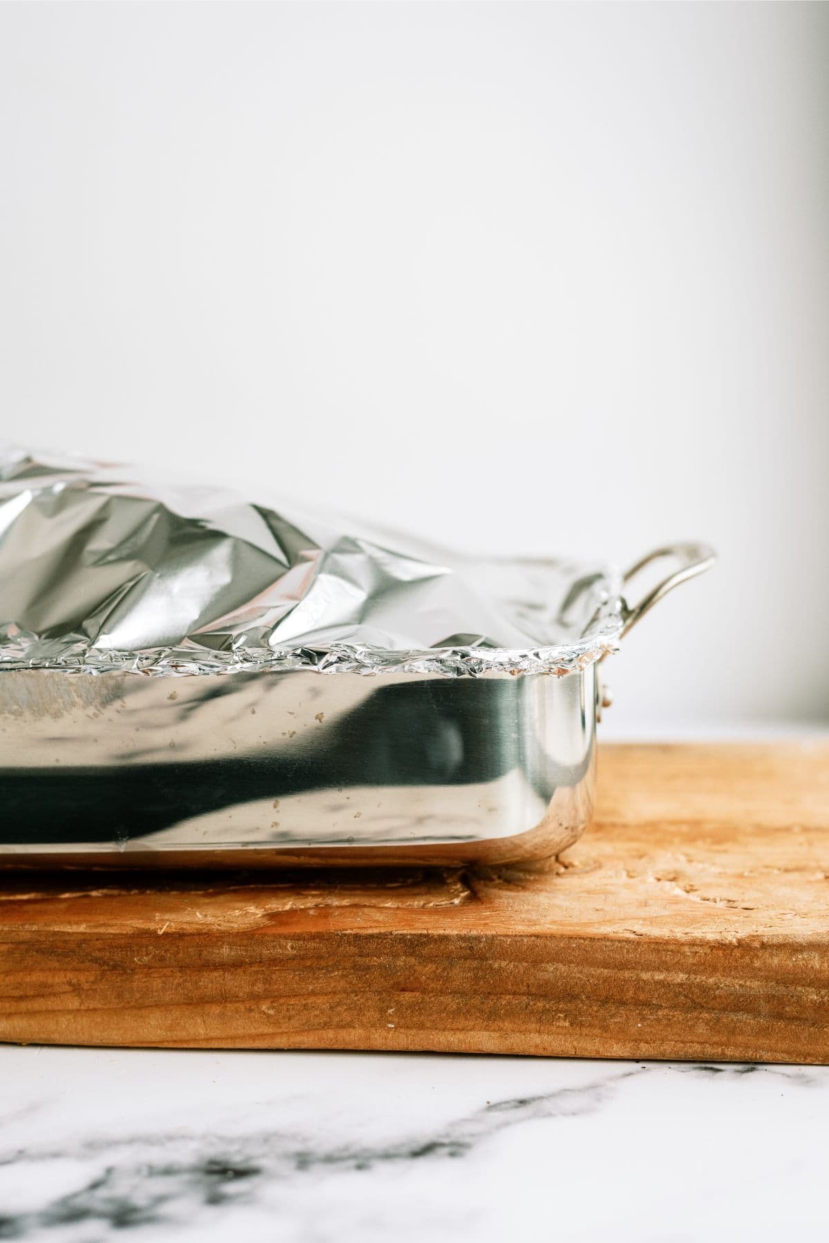 Pork roast in pan covered with foil