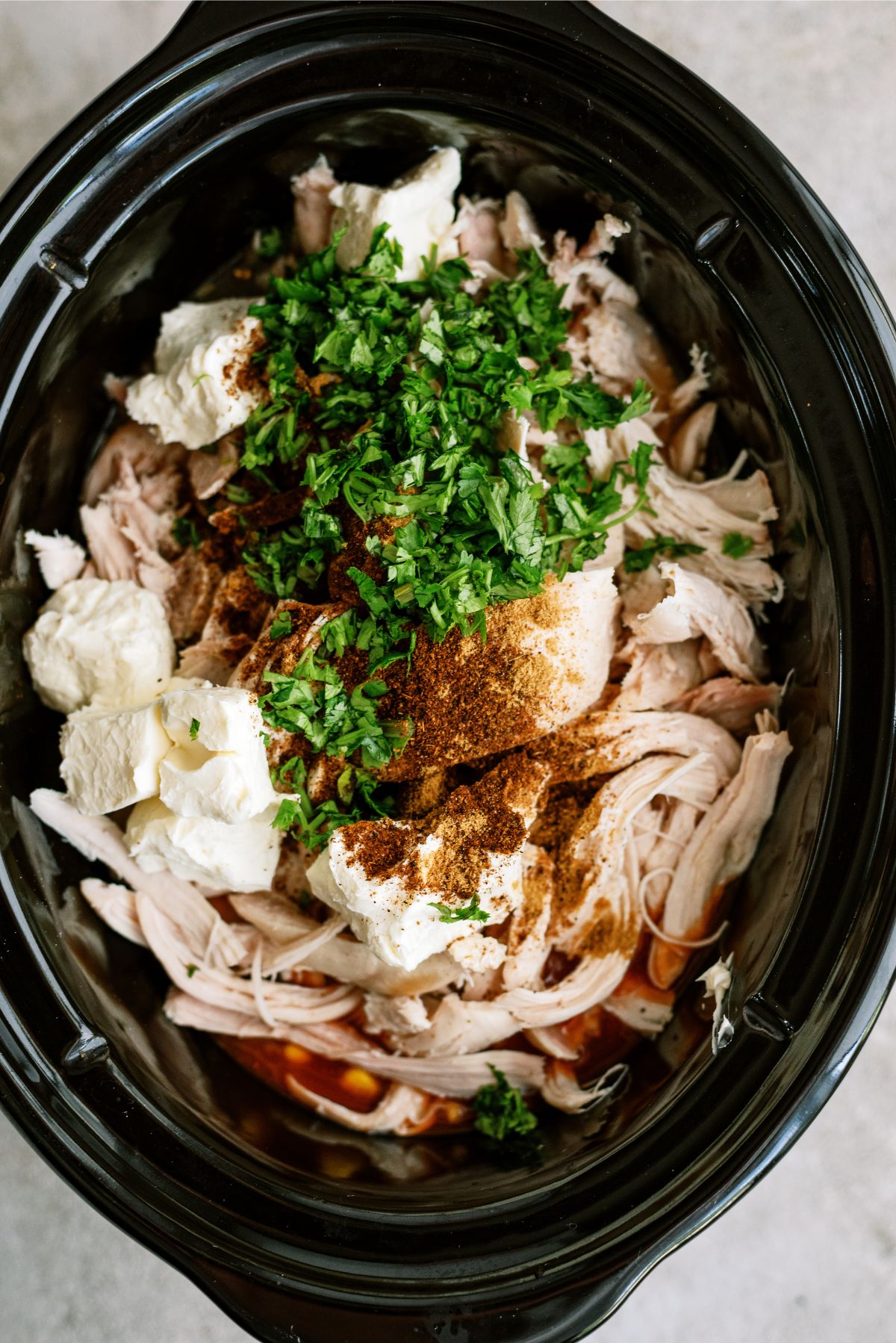 All ingredients for Slow Cooker Chicken Enchilada Pasta except Orzo pasta in the slow cooker