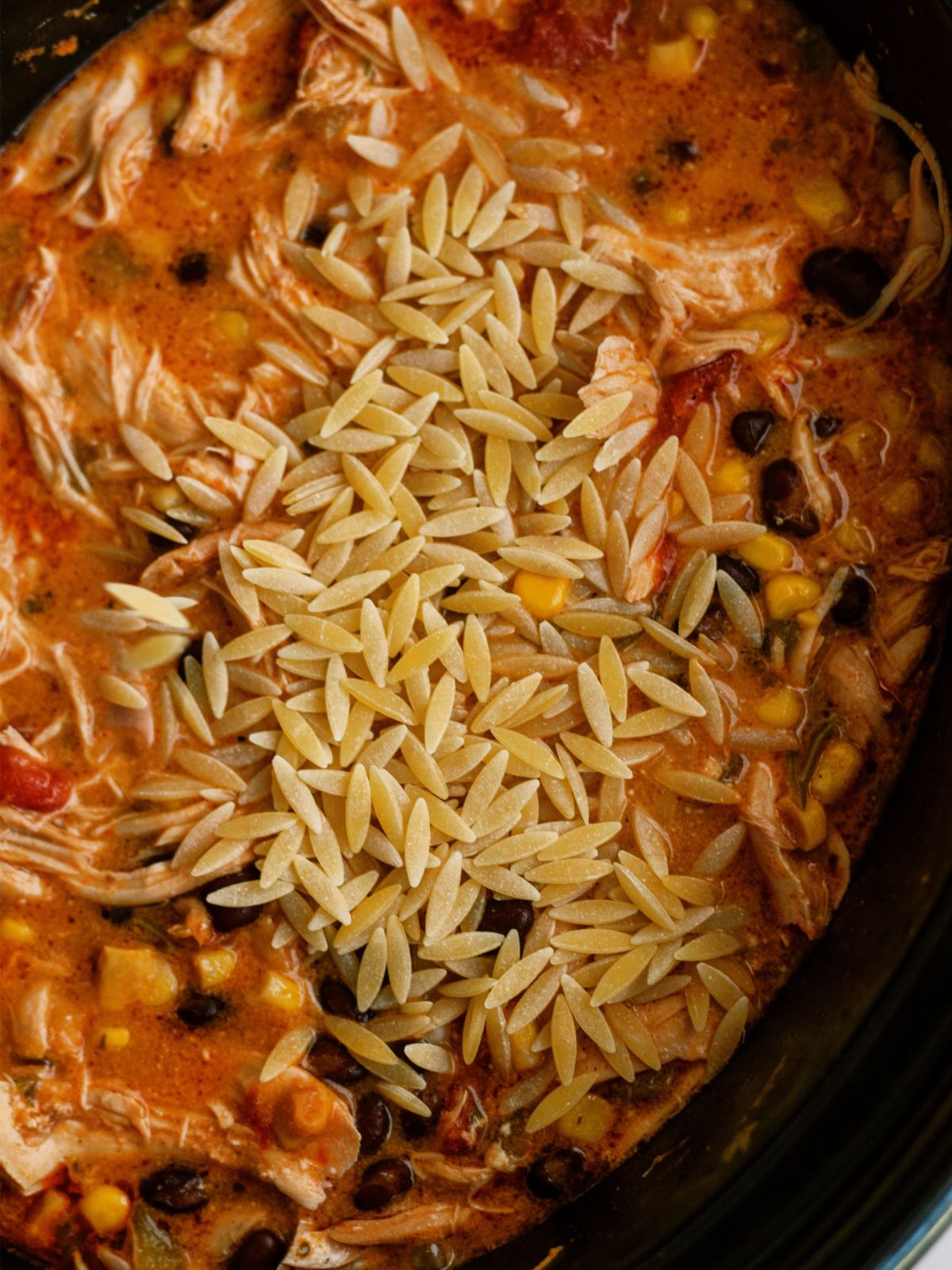 Orzo pasta added to slow cooker
