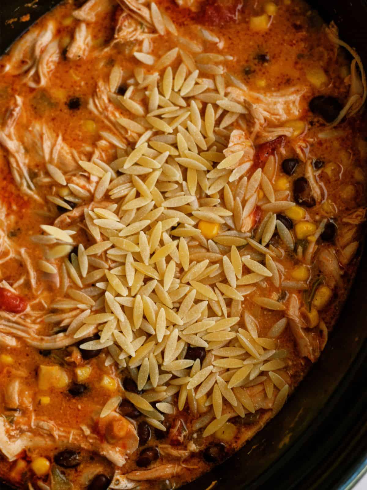 Orzo pasta added to slow cooker