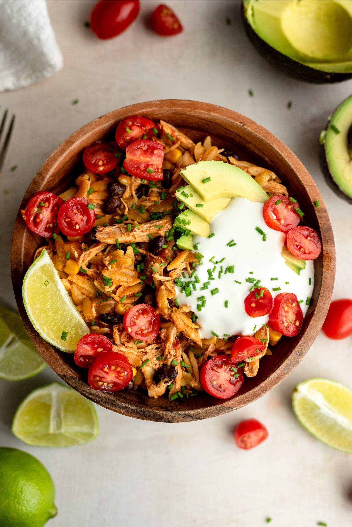 Slow Cooker Chicken Enchilada Pasta in a bowl with toppings