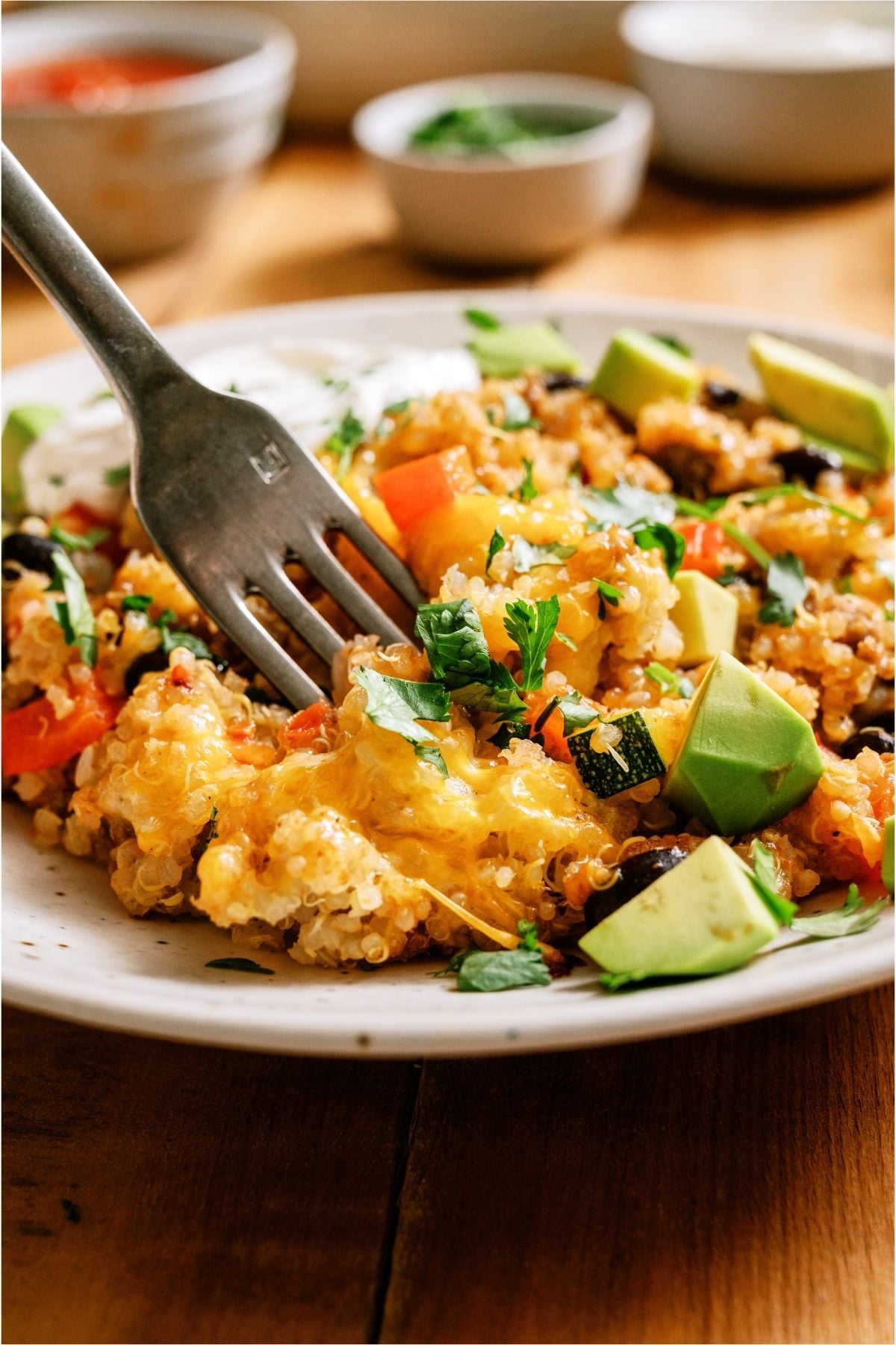 A serving of Zucchini Taco Casserole on a plate with a fork.