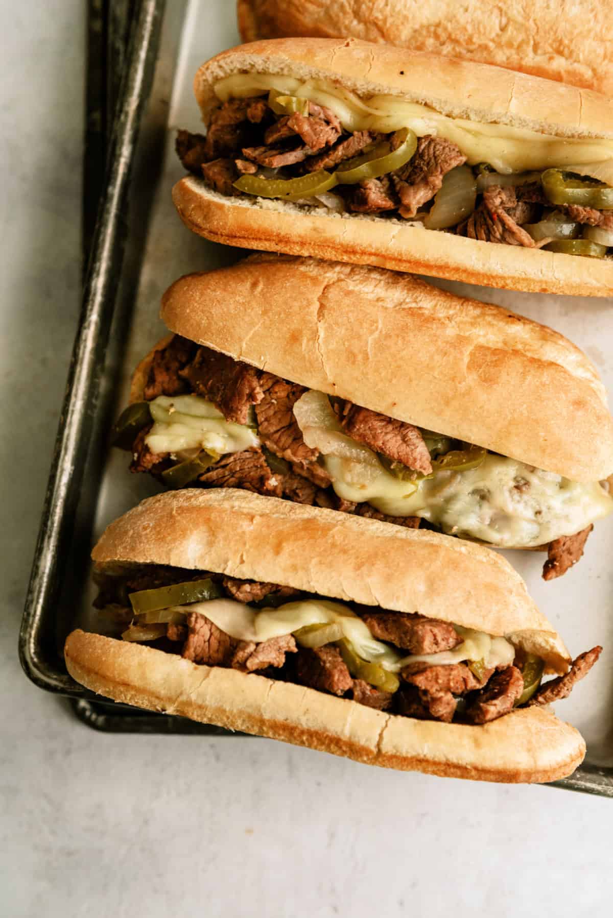 Instant Pot Philly Cheesesteak Sandwiches on a sheet pan.