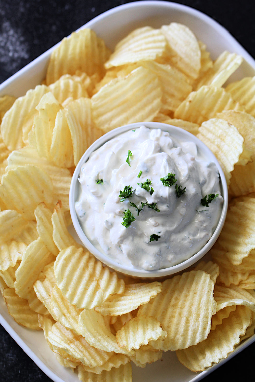 A bowl of chips with Easy French Onion Dip in the middle
