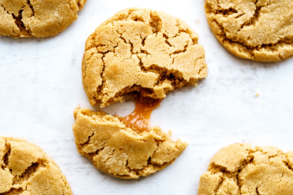 Apple Cider Caramel Cookies with one broken in half to show the caramel filling