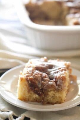 A slice of Cinnabon Cinnamon Roll Cake on a plate.