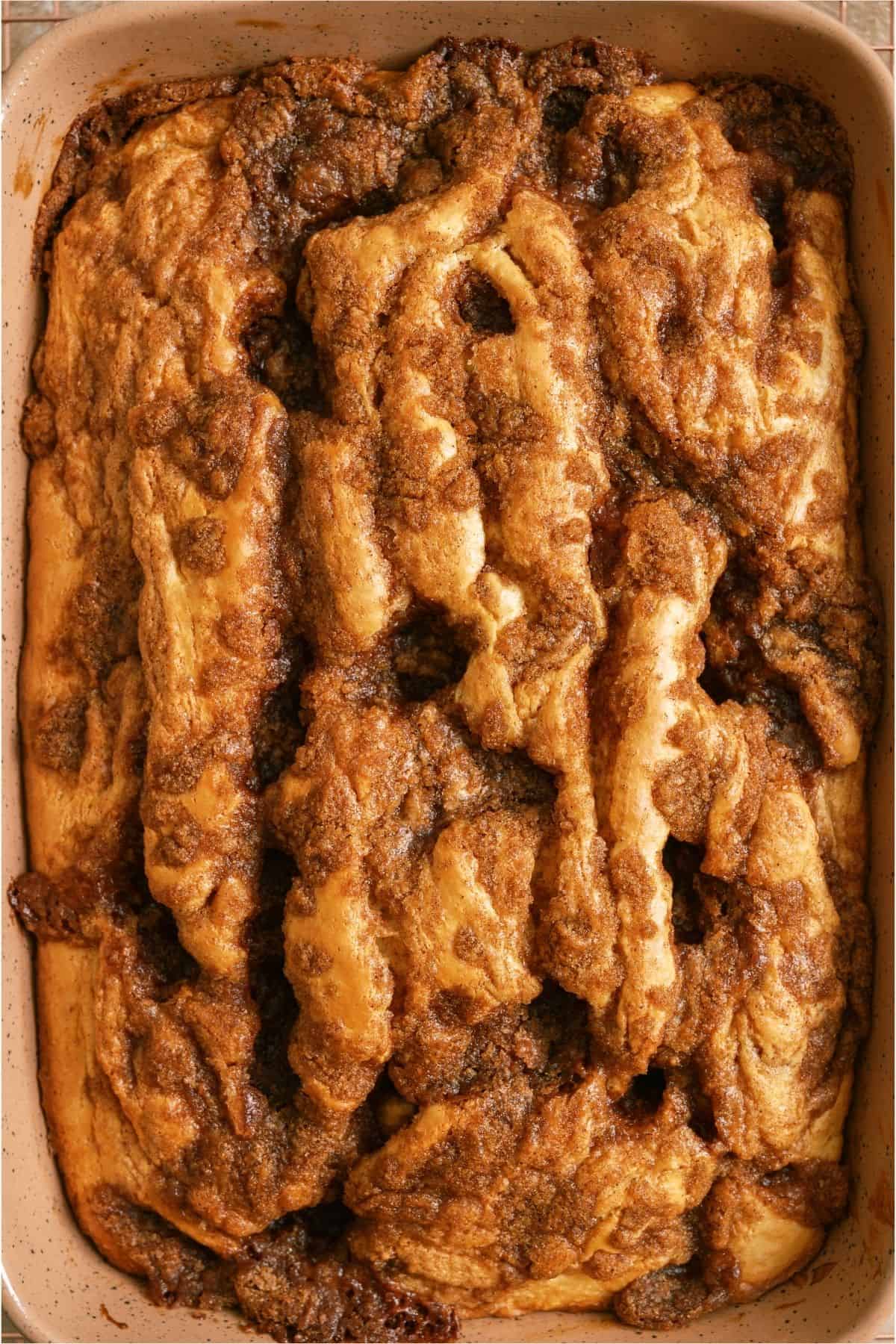 Top view of unfrosted Cinnabon Cinnamon Roll Cake in a baking dish.