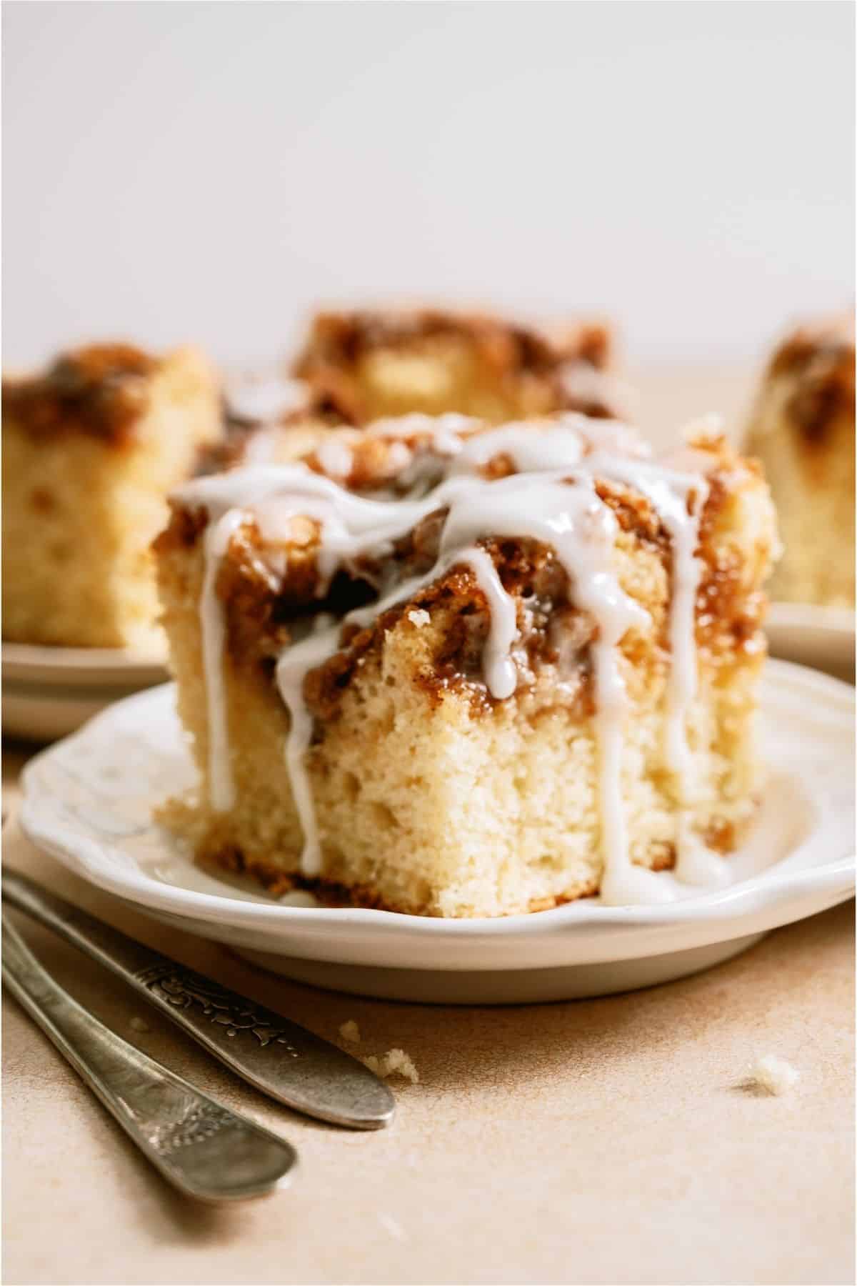 Close up of a frosted slice of Cinnabon Cinnamon Roll Cake.