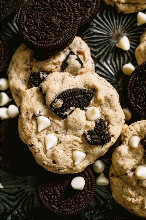 Cookies and Cream Cookies on a dark background with white chocolate chips.