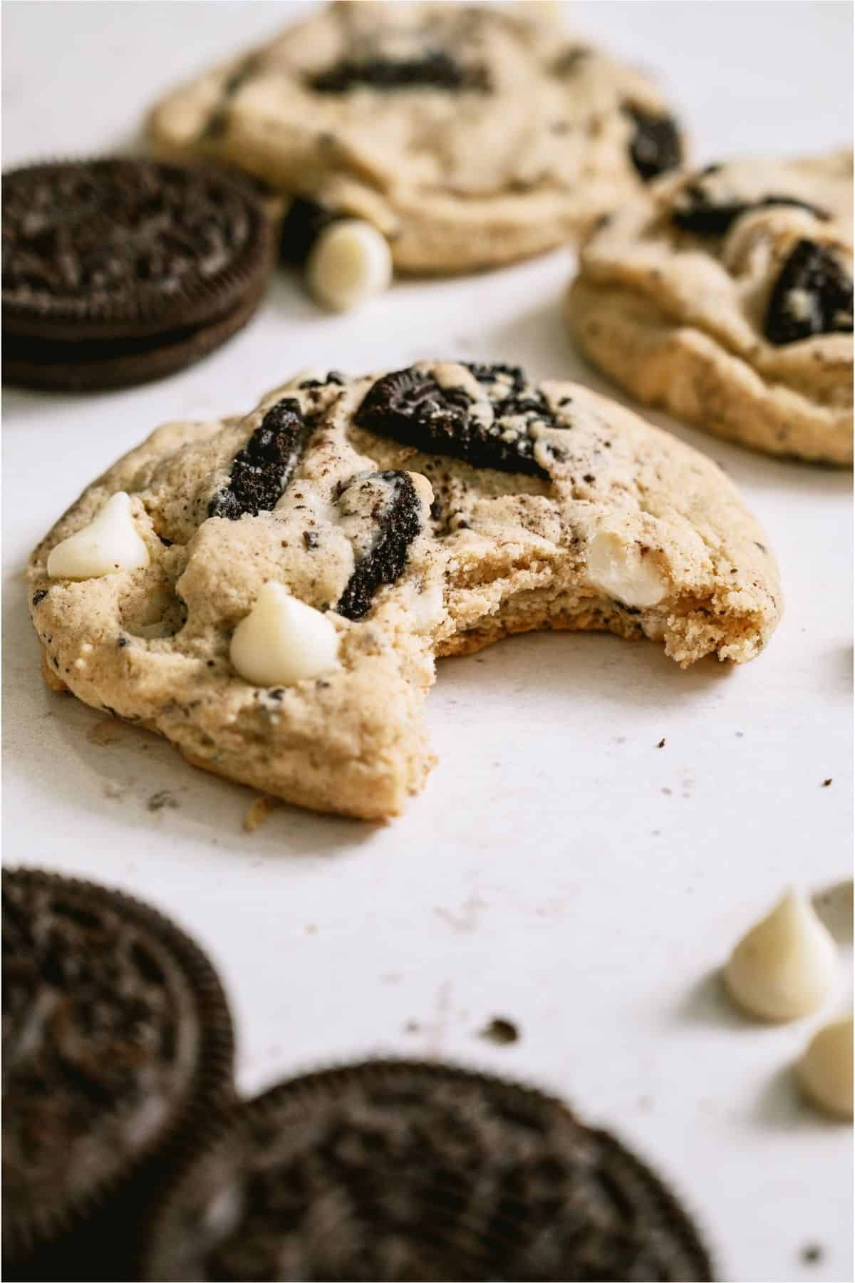 Side view of a Cookies and Cream Cookie with a bite missing.