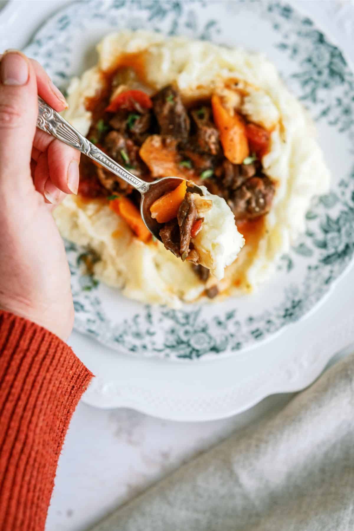 A spoonful of Instant Pot Beef Daube Stew with Mashed Potatoes 