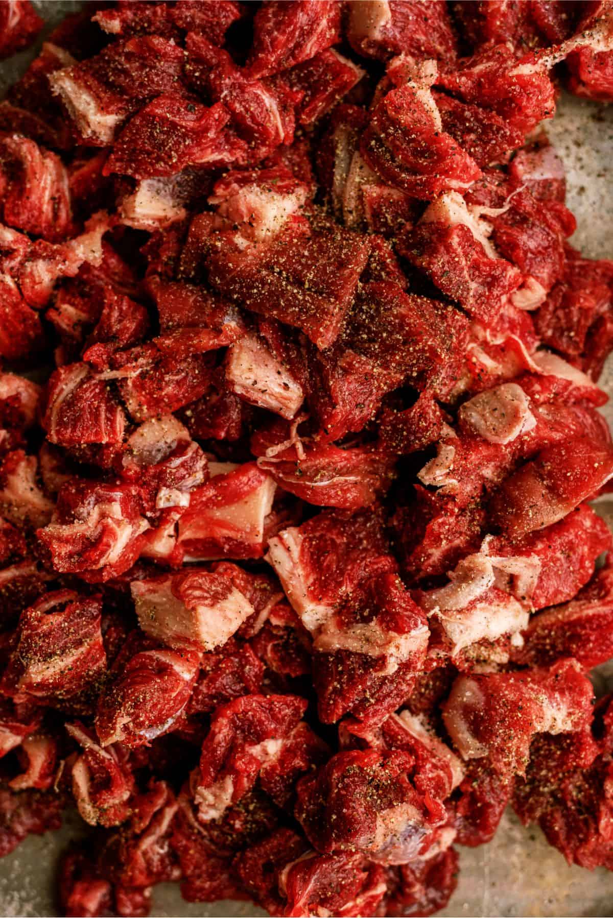 Seasoned beef cubes on cutting board