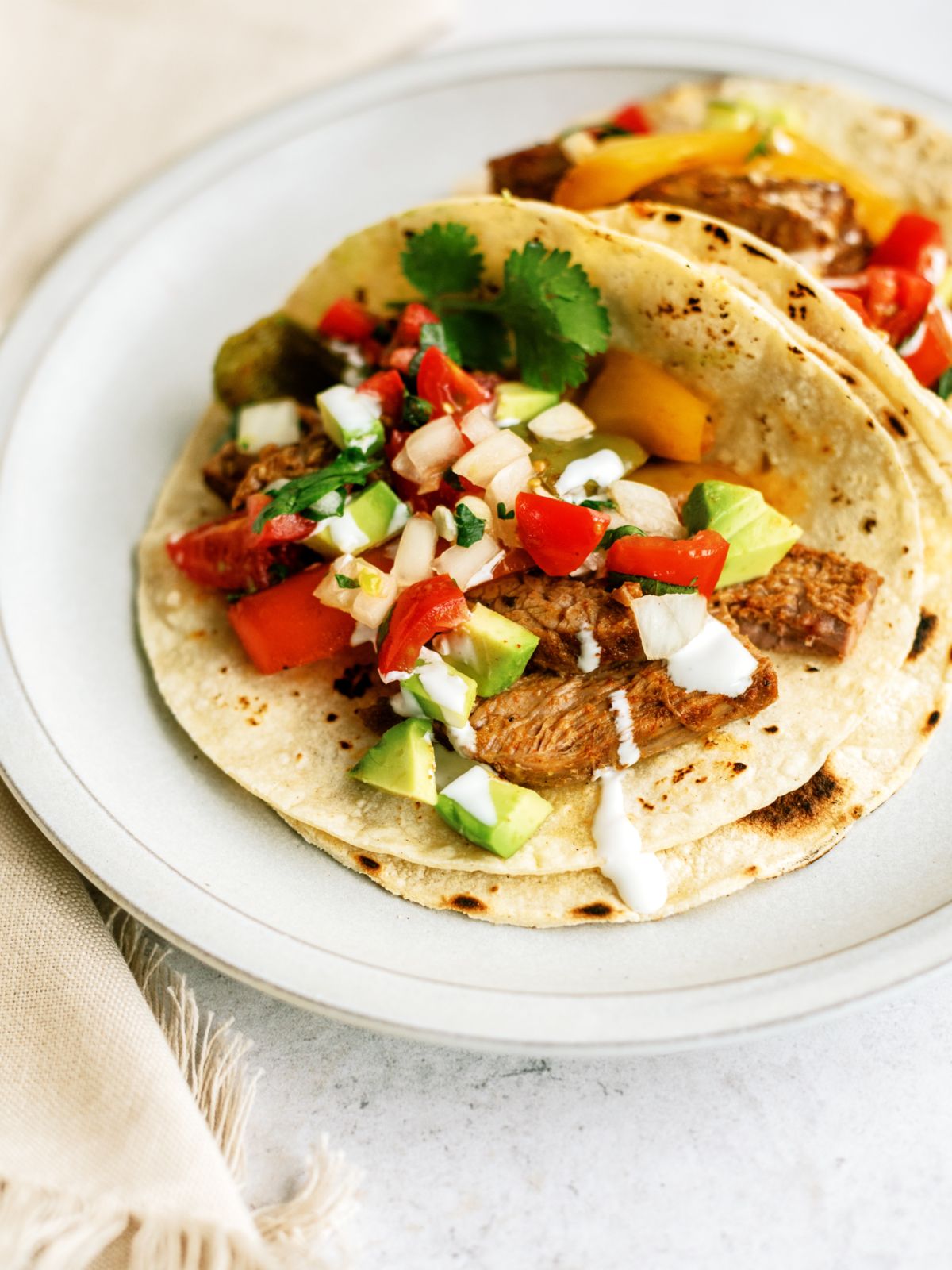 Instant Pot Steak Fajitas on a plate with toppings
