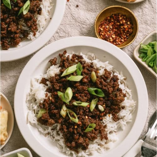 A serving of Korean Beef and Rice in a white bowl.