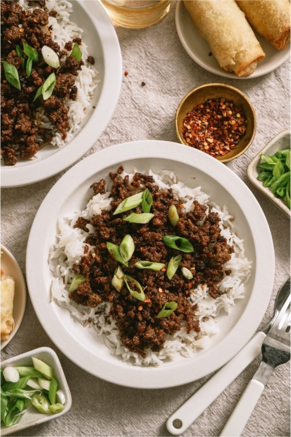 A serving of Korean Beef and Rice in a white bowl.