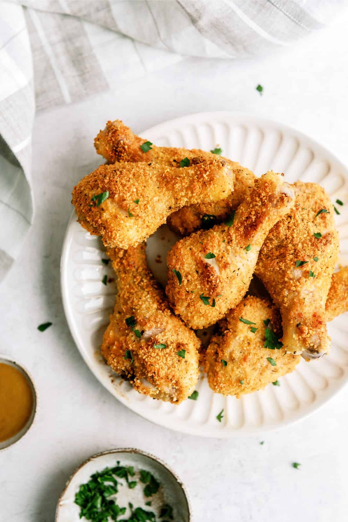 Oven-Fried Parmesan Chicken Drumsticks on a serving plate