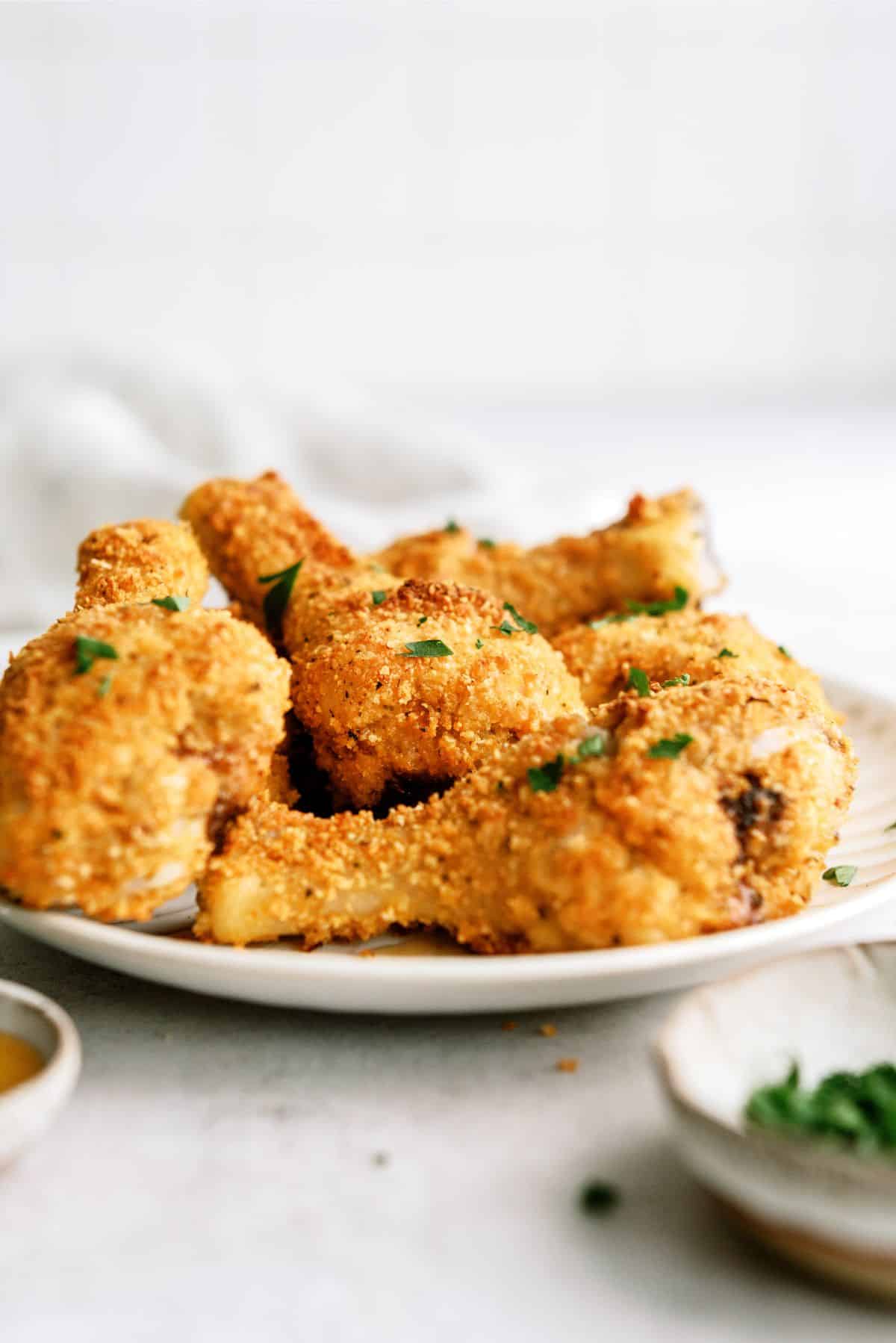 Oven-Fried Parmesan Chicken Drumsticks on a serving plate