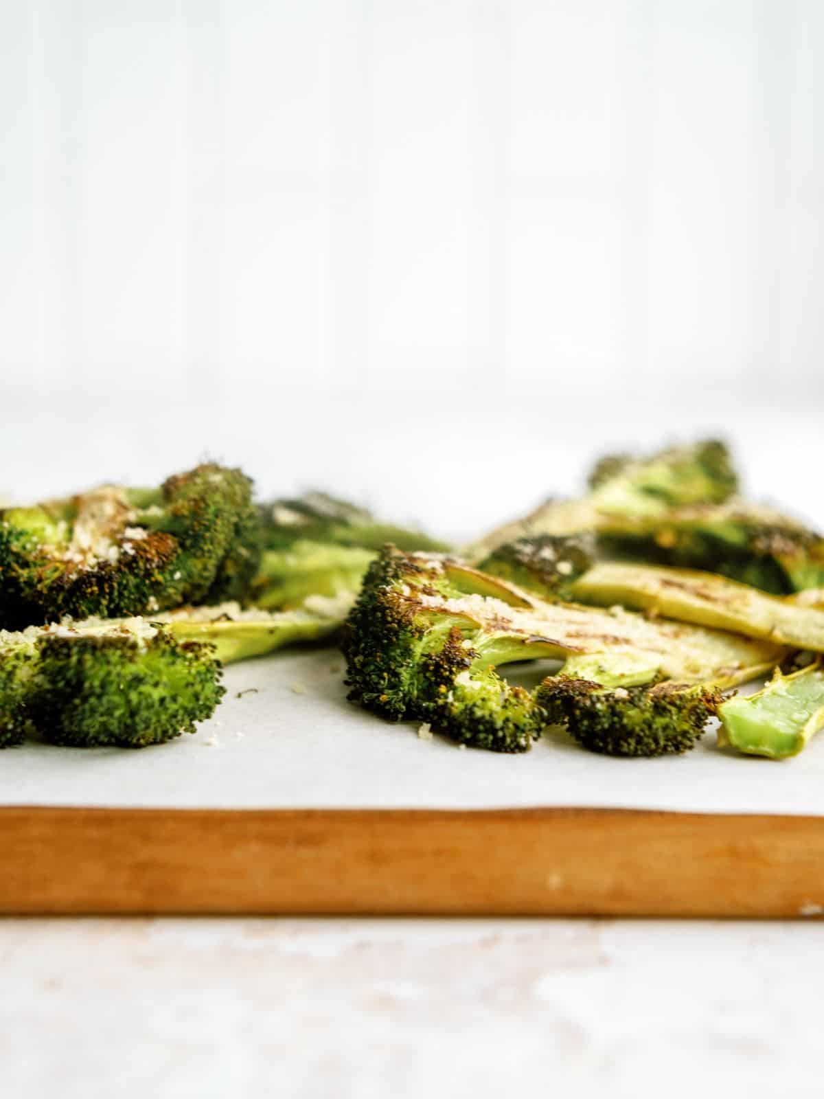 Side view of Oven-Roasted Broccoli Steaks on a cutting board