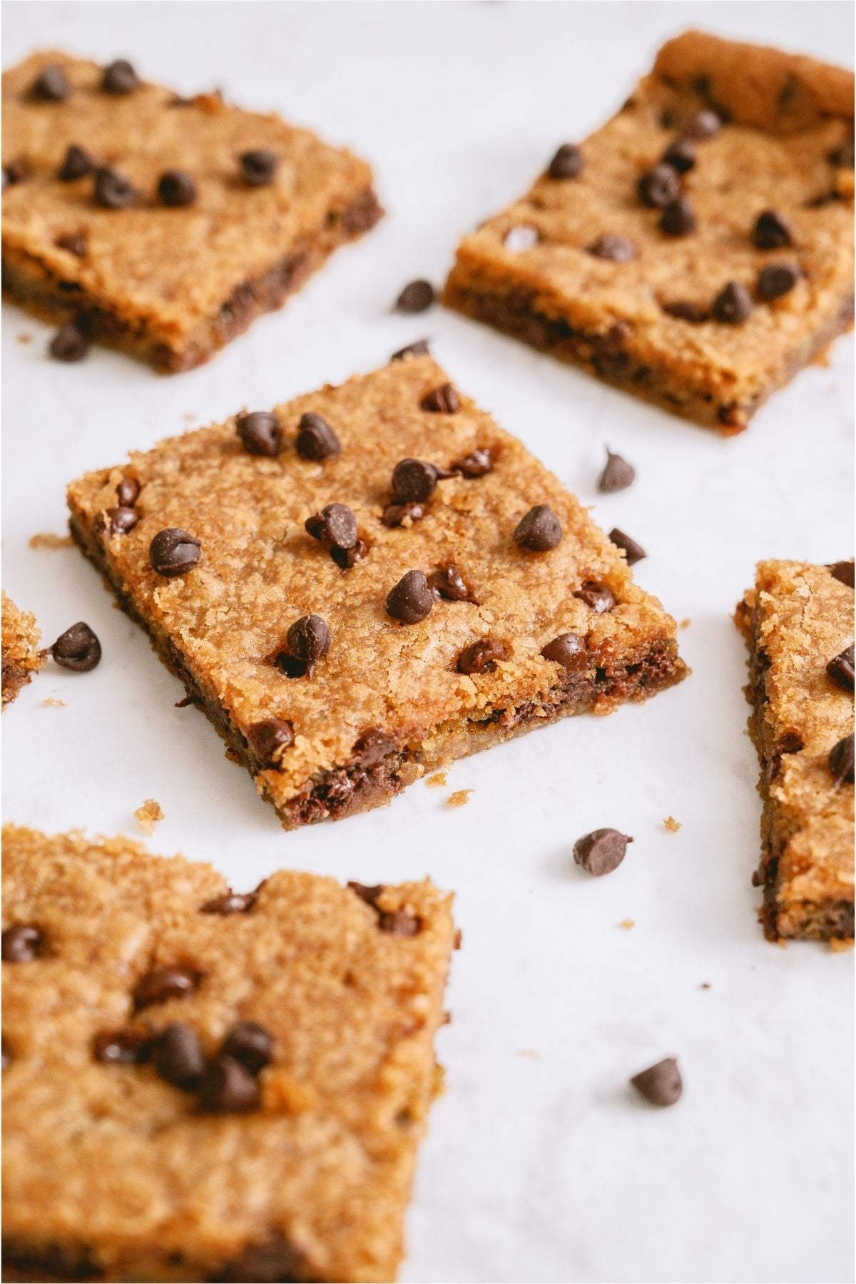 Sheet Pan Chocolate Chip Cookie Bars cut into squares on a white background.