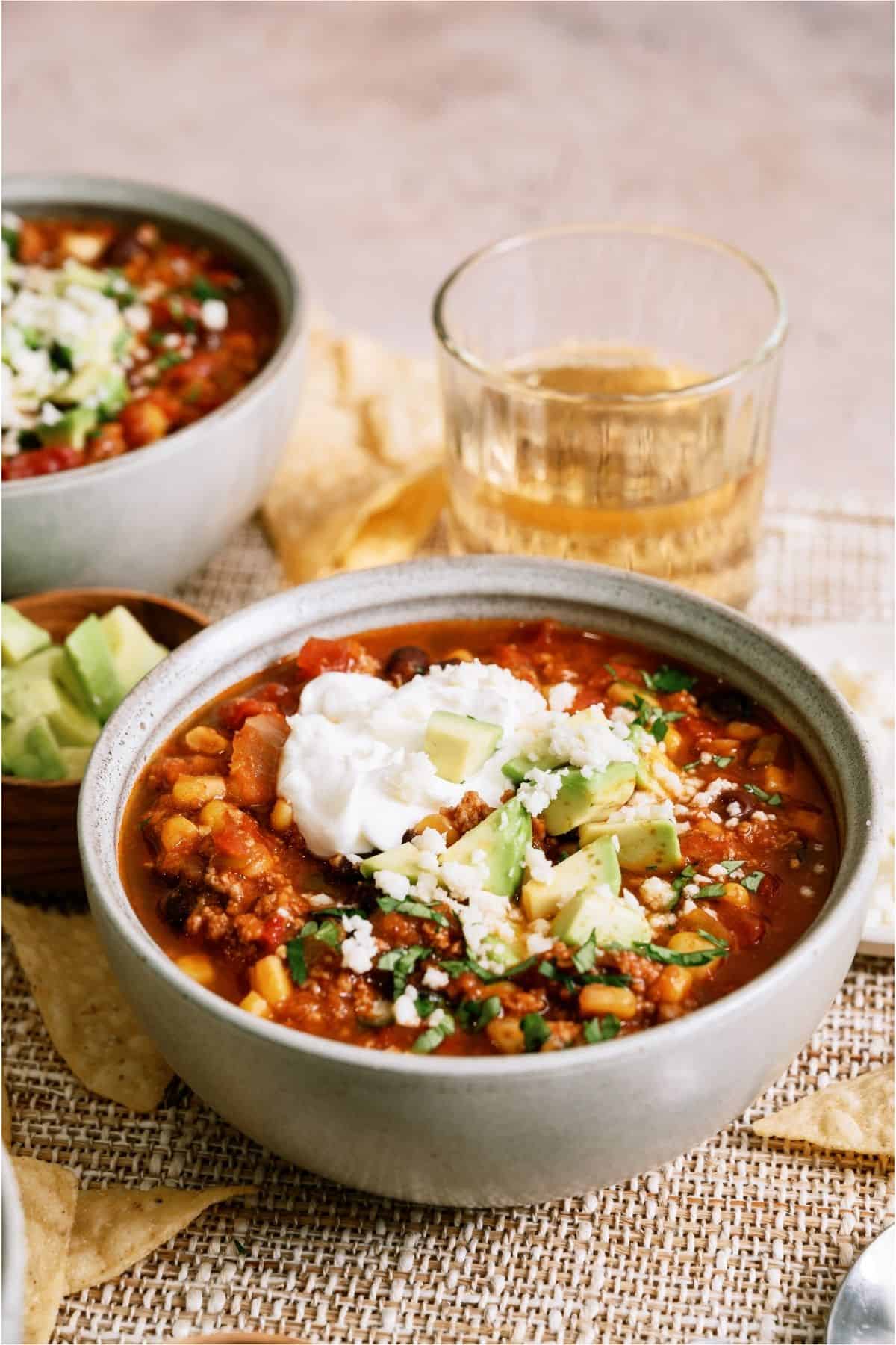 A bowl of Black Bean Taco Soup with toppings.