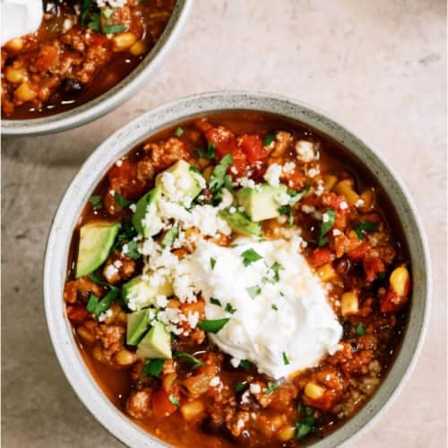 A bowl of Black Bean Taco Soup with toppings.