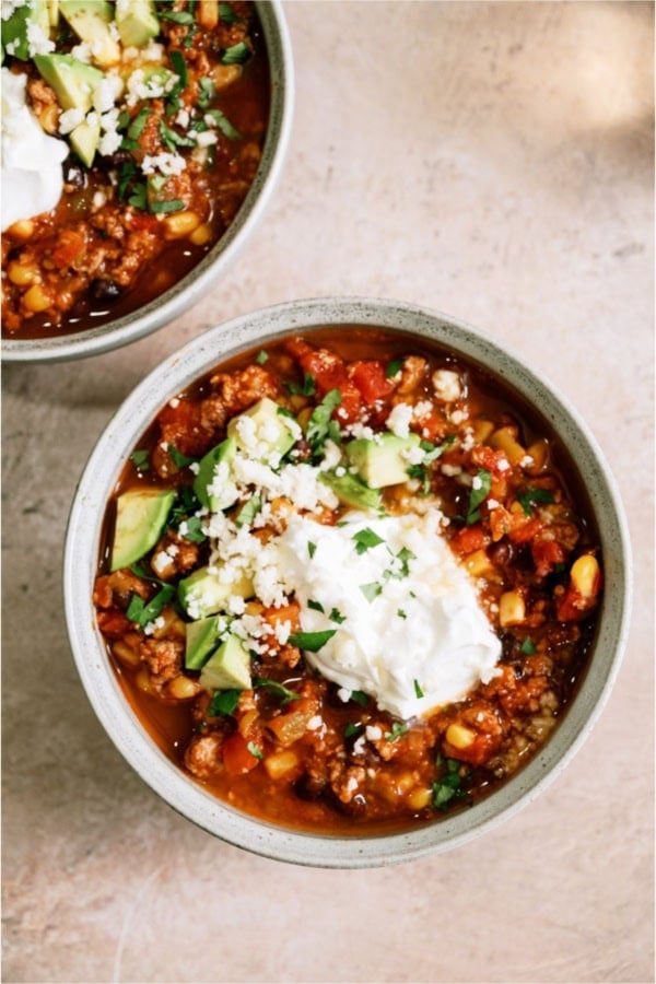 A bowl of Black Bean Taco Soup with toppings.