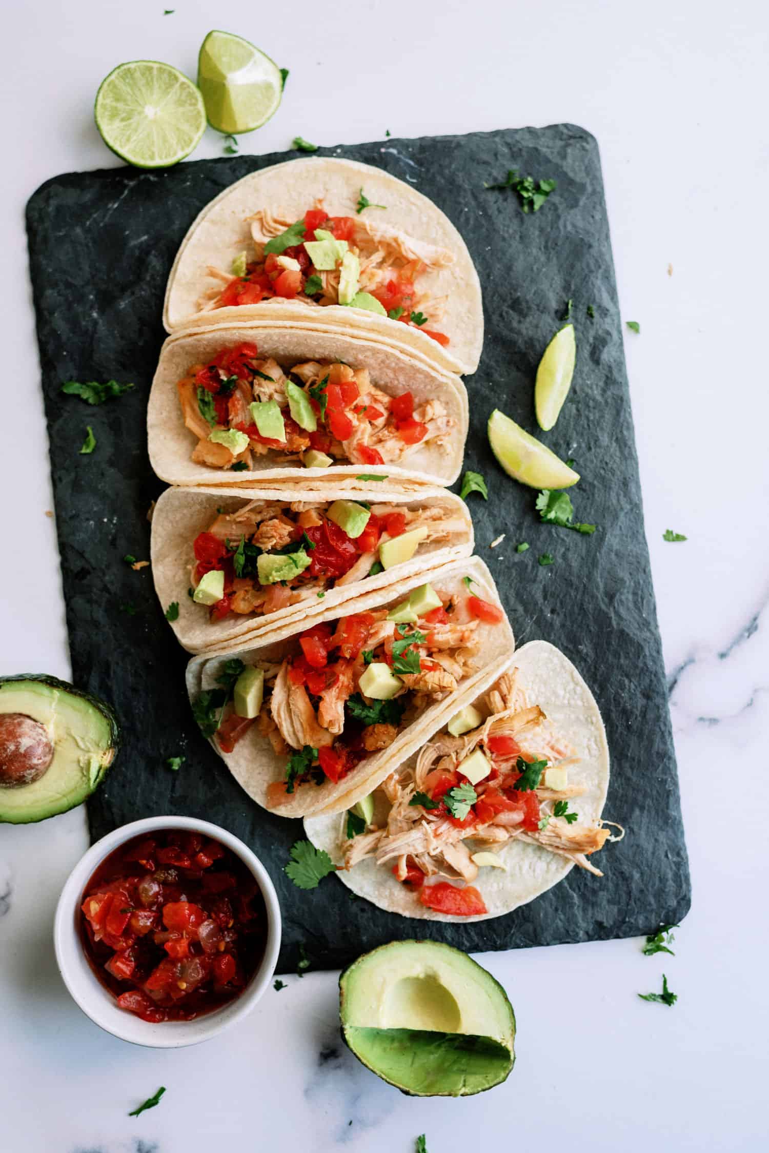 Slow Cooker Chicken Carnitas on a cutting board 