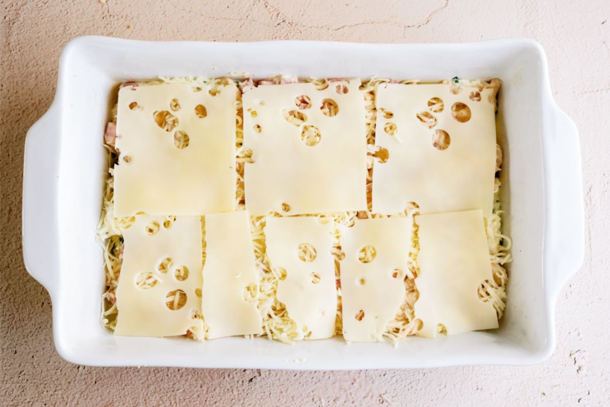 Swiss cheese slices on top of casserole.