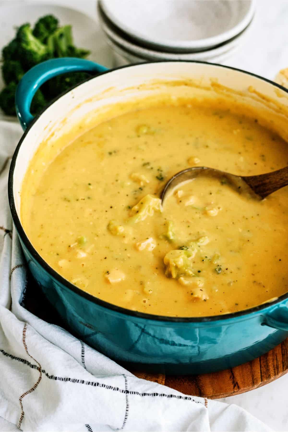 A pot of Chicken and Broccoli Cheese Soup with a ladle