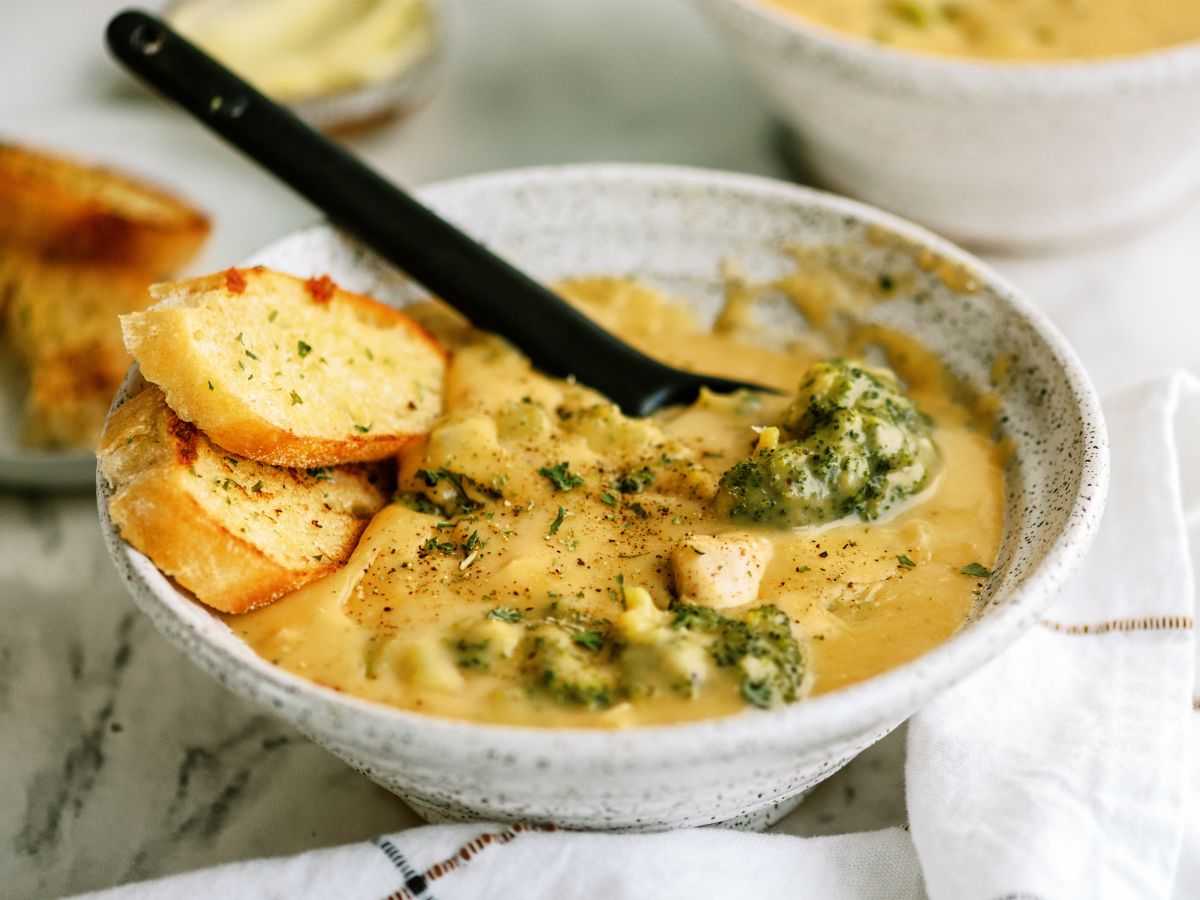 Close up of a bowl of Chicken and Broccoli Cheese Soup with a spoon
