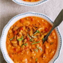 Top view of 2 bowls of Creamy Ground Beef and Tomato Macaroni Soup,
