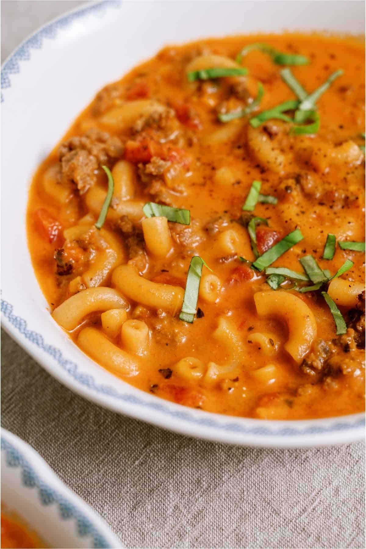 Close up of a bowl of Creamy Ground Beef and Tomato Macaroni Soup.
