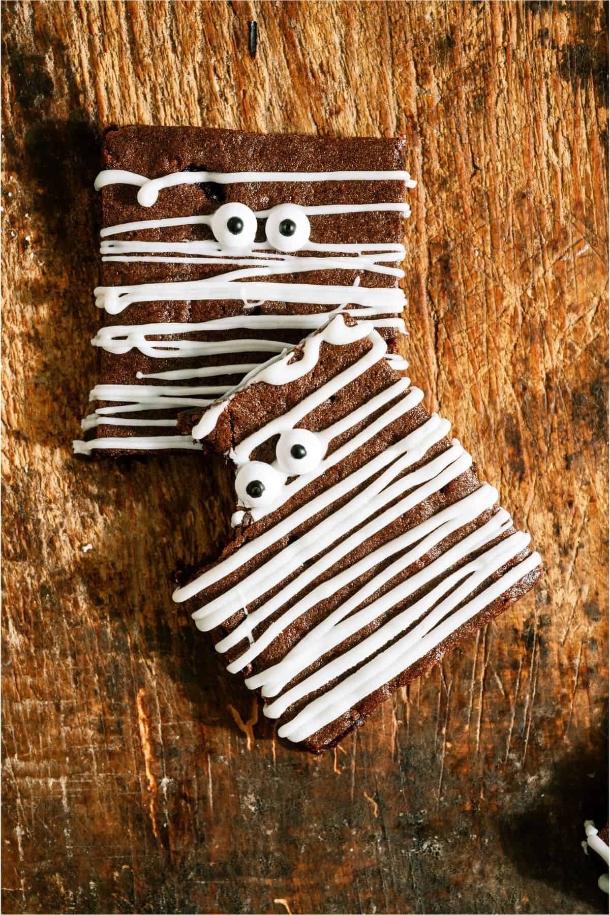 2 Halloween Mummy Brownies stacked, with the top one missing a bite.