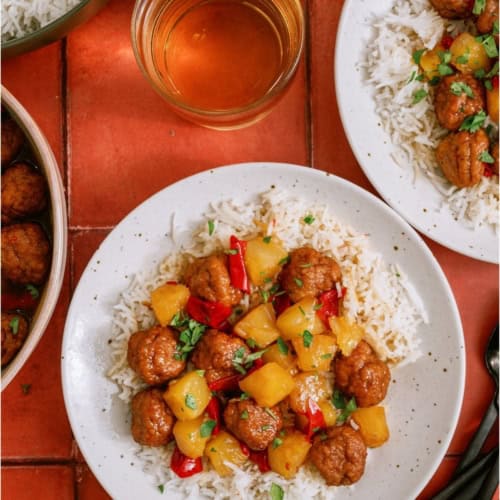 Top view of Instant Pot Hawaiian Meatballs served over rice on a plate.